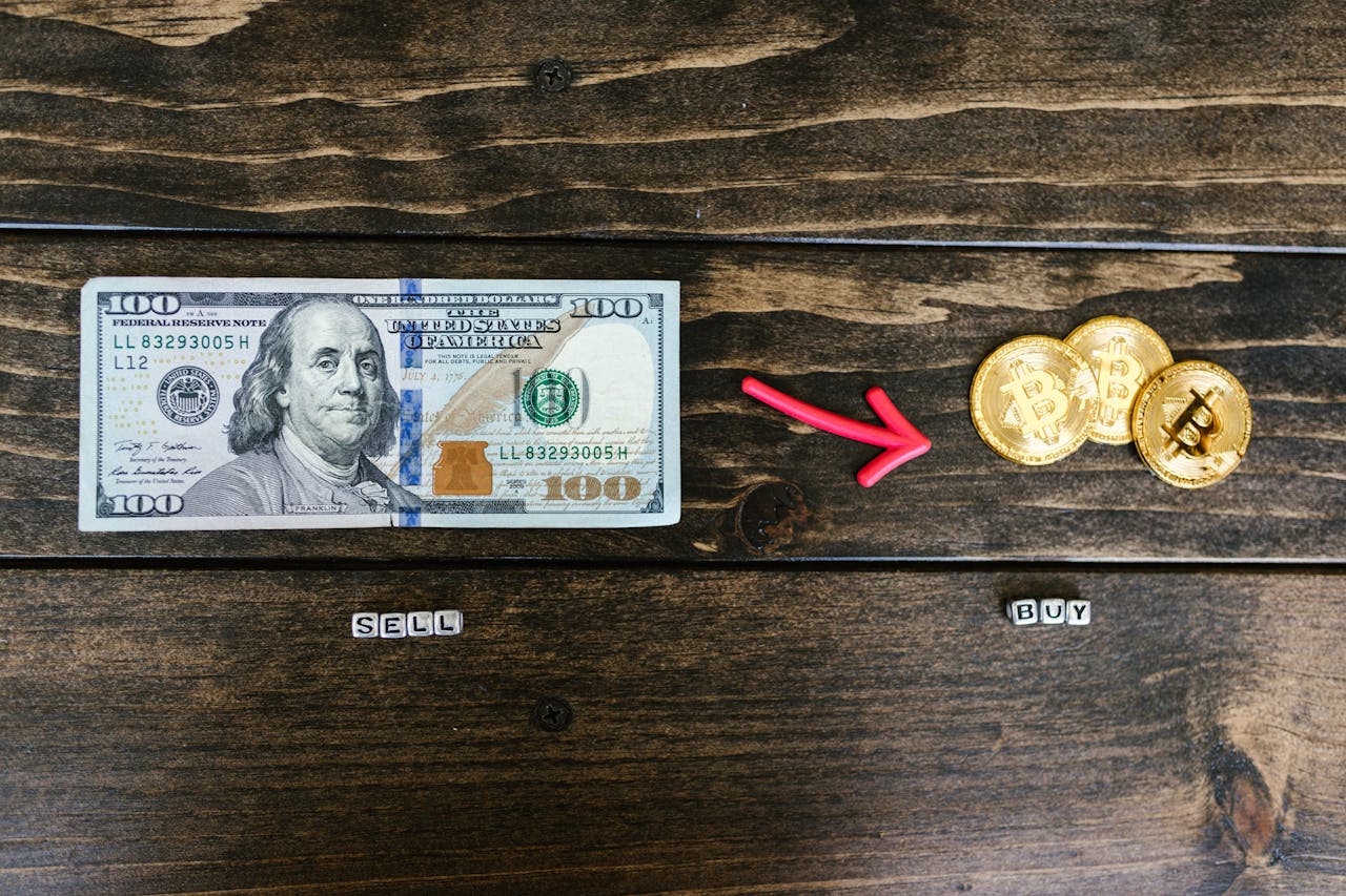 Bitcoin coins and a dollar bill symbolize digital and traditional currency trade.